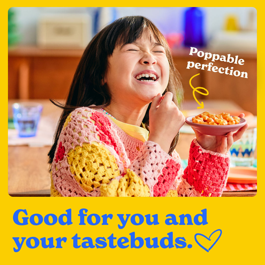 Good for you and your tastebuds: a child happily eating MadeGood star puffed crackers