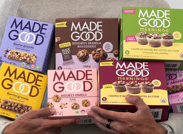 A person holding various boxed madegood products