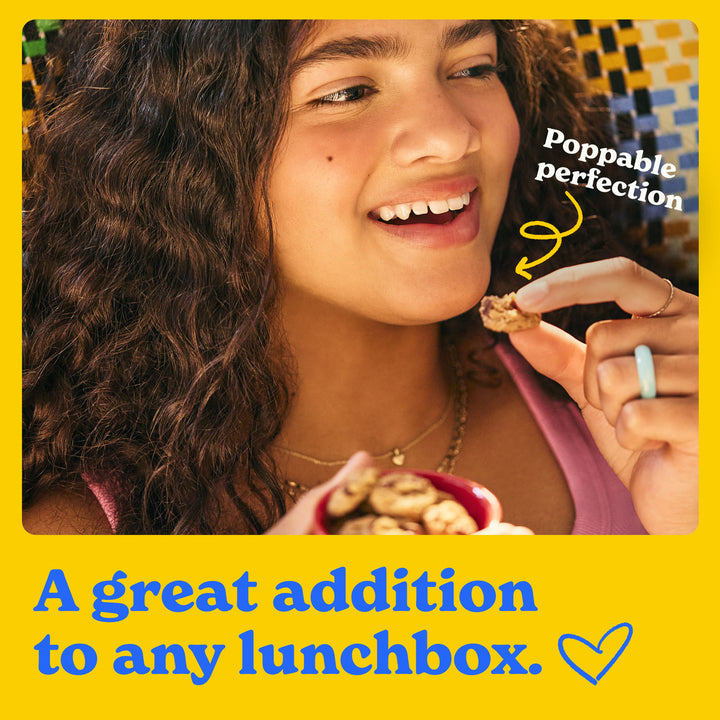 A great addition to any lunchbox: a girl eating a soft baked mini cookie that's poppable perfection