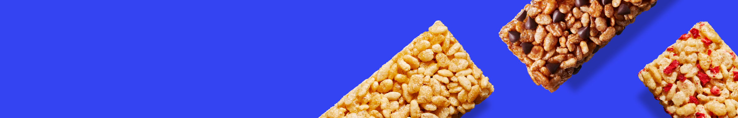Three different granola bars are placed diagonally on a vibrant blue background. One is plain, another has chocolate chips, and the third has red berry pieces.