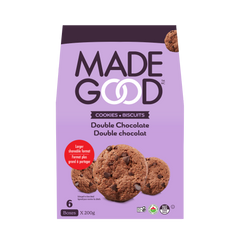 A purple package of MadeGood Double Chocolate Cookies is displayed. The packaging features the brand name in bold uppercase letters with interlocking "O"s. Below, "Cookies • Biscuits" and "Double Chocolate" appear in both English and French. An image of chocolate chip cookies is at the bottom. A red label indicates a "Larger shareable format." The package states it contains six boxes (200g each) and includes certifications such as organic and nut-free.